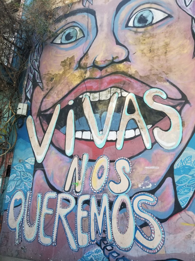 Mural of a woman saying "Vivas Nos Queremos" (we want us alive)